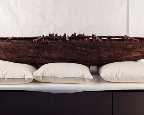 model of ancestral yagan canoe on table in museum storage room