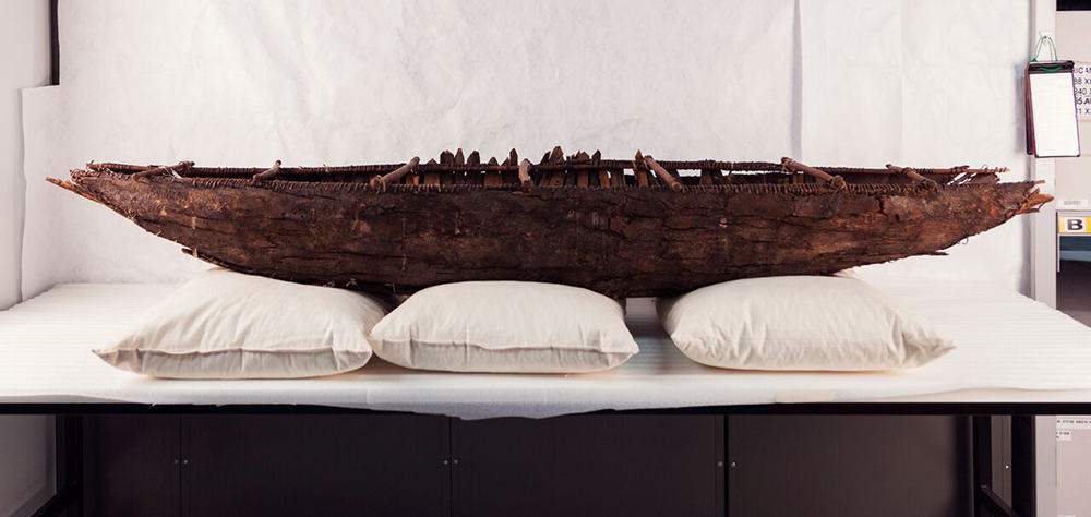 model of ancestral yagan canoe on table in museum storage room